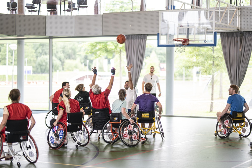 Corporate group playing wheelchair basketball for a CSR activity.